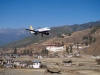 Druk Air plane flying past Paro Dzong